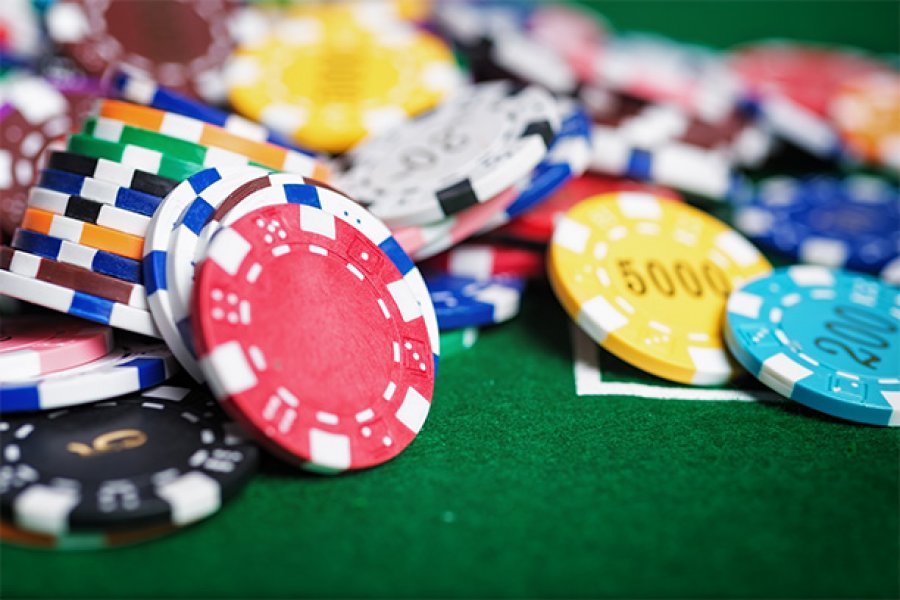 Casino poker chips in a green felt background.