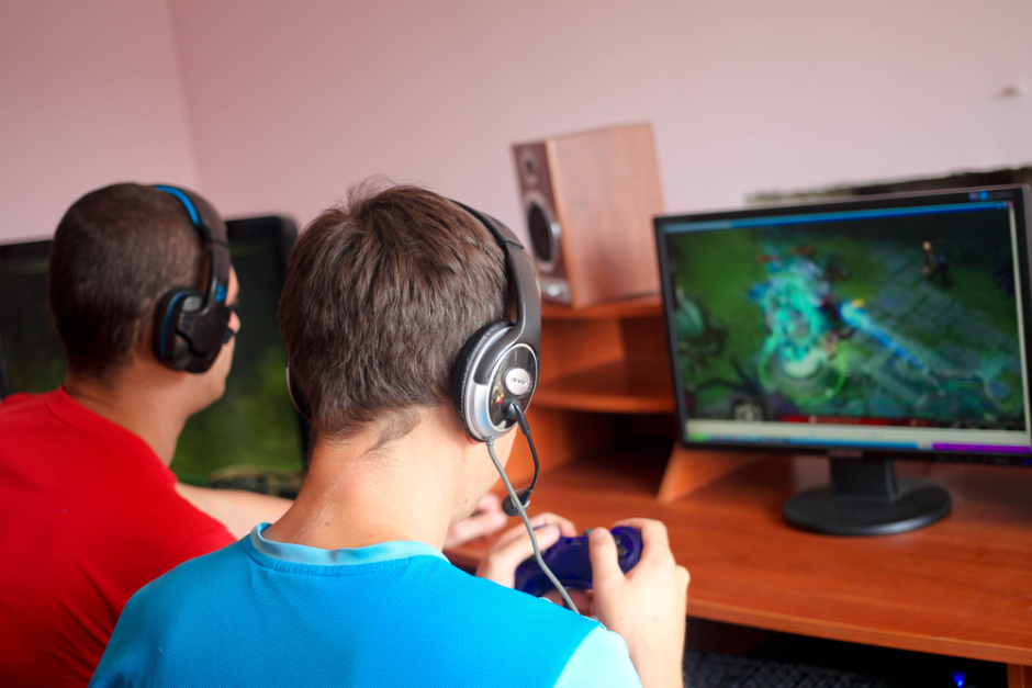 Two Boys playing clash of clans in a video game centre.